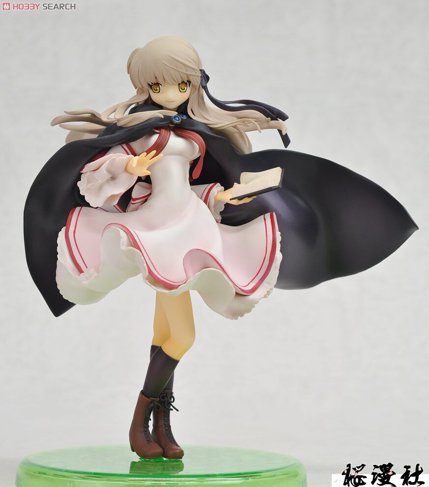 Figurine of a character with long hair and a large black object on a white background