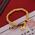 Männer und Frauen 9999 24K Echtgold Neue chinesische glatte Goldklumpen Frieden Freude Geld gewickeltes rotes Seilarmband Einfacher China-Chic