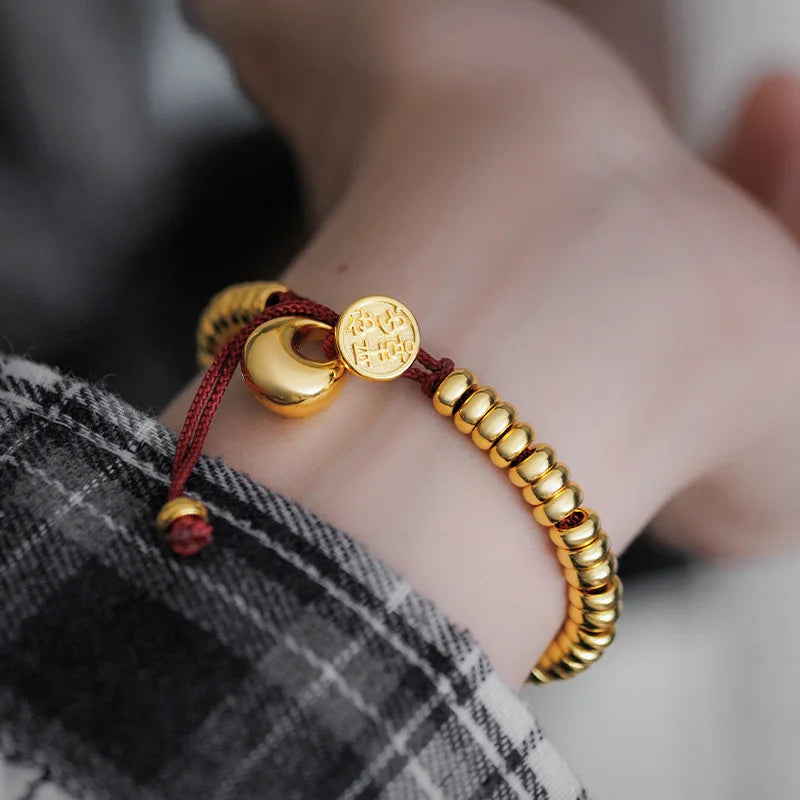 Männer und Frauen 9999 24K Echtgold Neue chinesische glatte Goldklumpen Frieden Freude Geld gewickeltes rotes Seilarmband Einfacher China-Chic