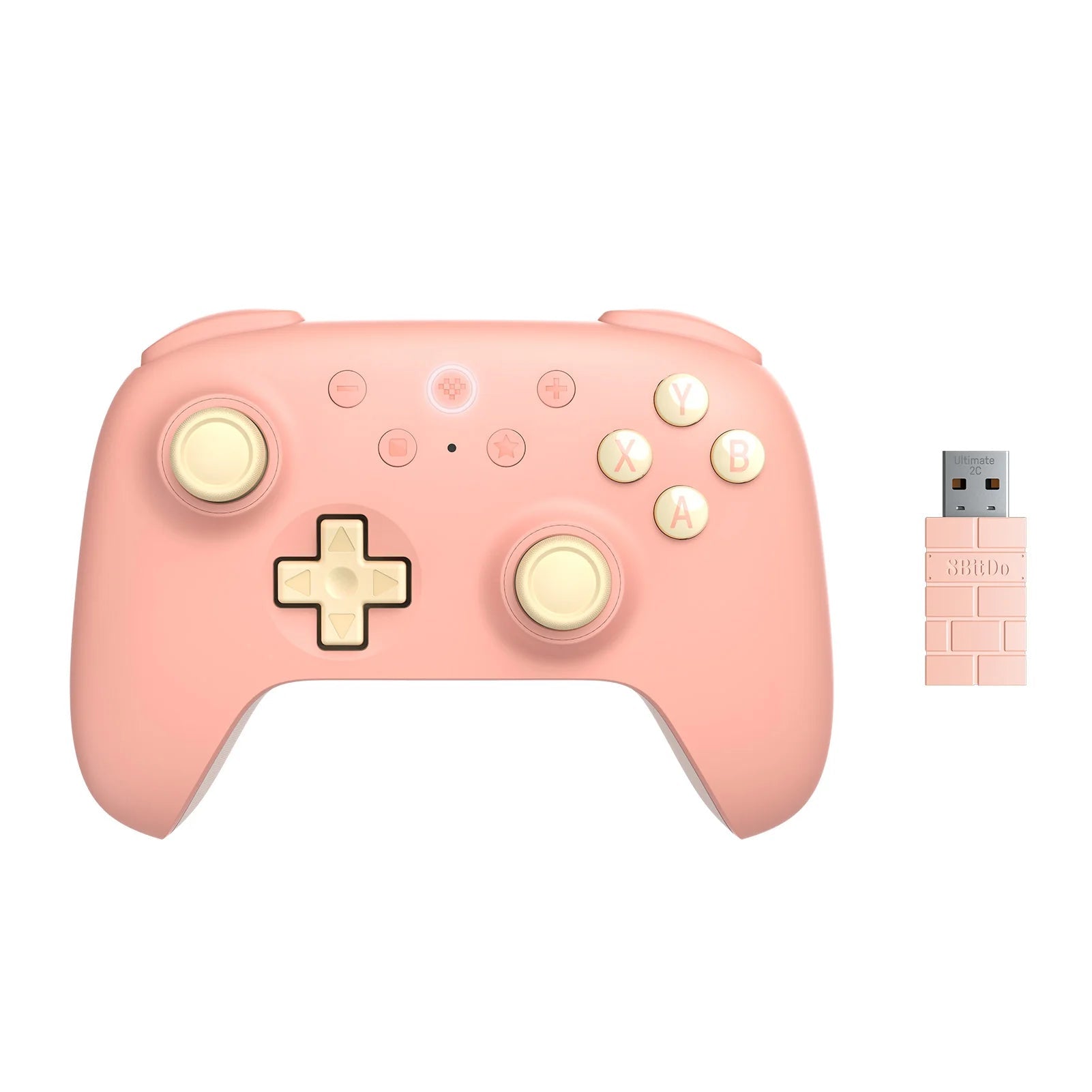 Pink gaming controller with gold accents and a USB adapter on a white background