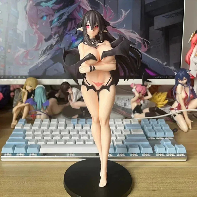 Anime figurine on a desk with a keyboard and other figurines in the background